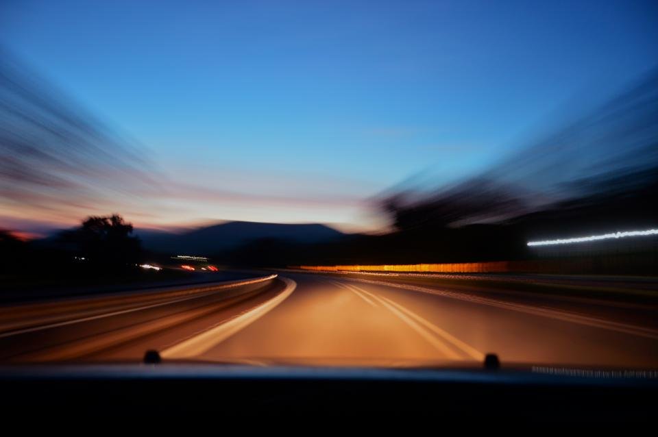 Person driving a car, looking for ways to save on car insurance