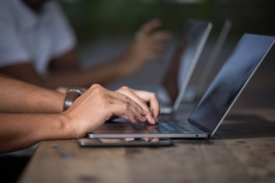 Freelancer working on a laptop, protected by professional liability insurance
